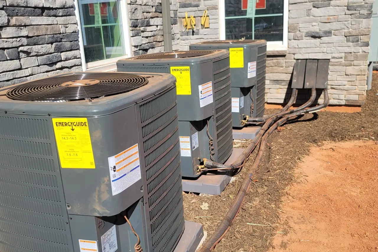 New air conditioning condensers beside a home