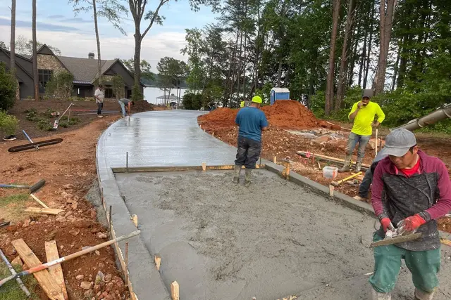 VO Remodeling LLC crew pouring and finishing a concrete driveway